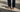 Person wearing brown Birkenstock sandals with casual outfit on street